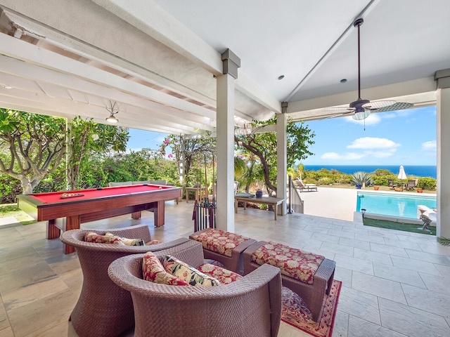 view of patio featuring a water view and ceiling fan