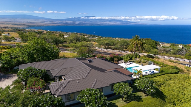 drone / aerial view featuring a water and mountain view