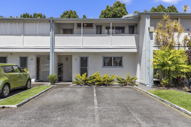 multi unit property featuring uncovered parking and a balcony