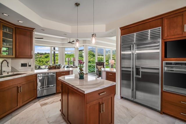 kitchen with dishwashing machine, wall oven, sink, a kitchen island, and refrigerator