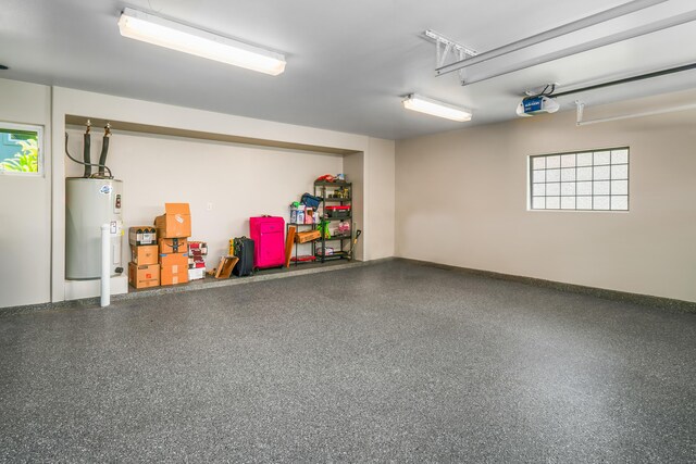 garage with water heater and a garage door opener