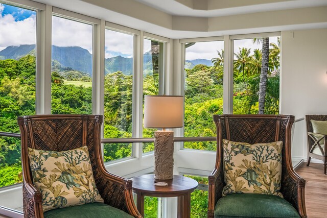 sunroom / solarium featuring a mountain view and a wealth of natural light