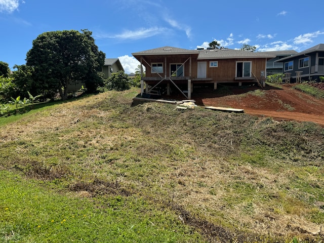 rear view of house with a yard