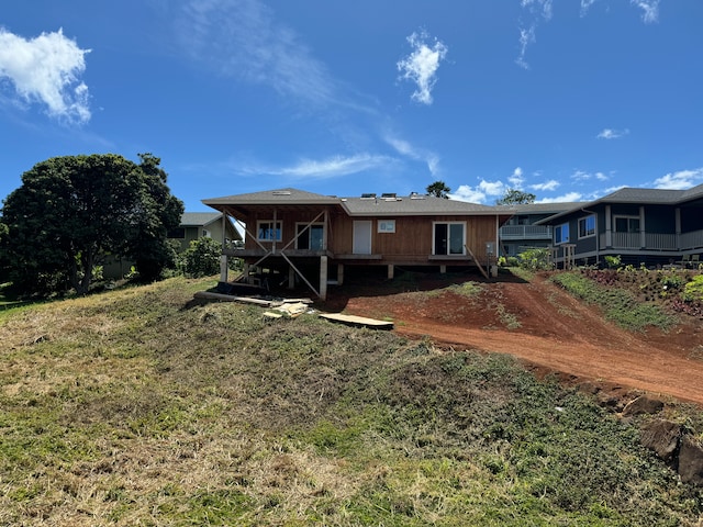 back of house with a lawn