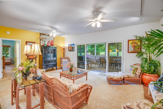 tiled living room with rail lighting and ceiling fan