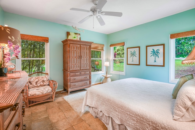 bedroom with ceiling fan and light tile patterned floors