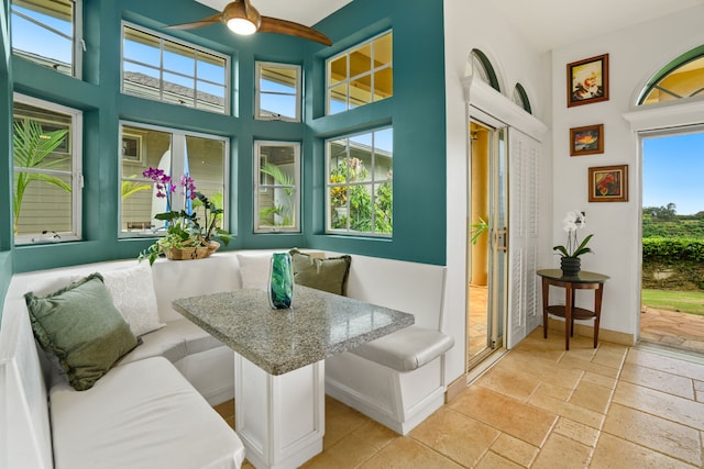 sunroom featuring ceiling fan