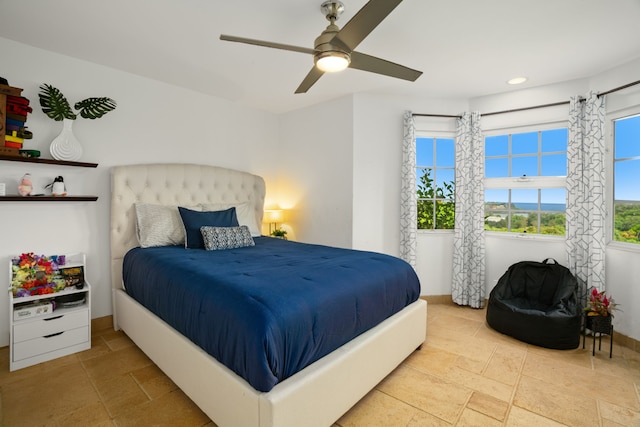 tiled bedroom featuring ceiling fan