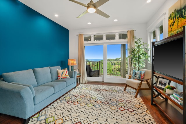 living room featuring ceiling fan and hardwood / wood-style flooring