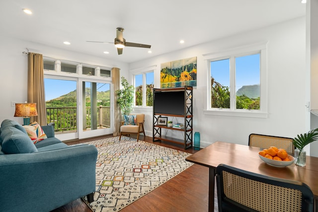 living room featuring plenty of natural light, hardwood / wood-style floors, and ceiling fan