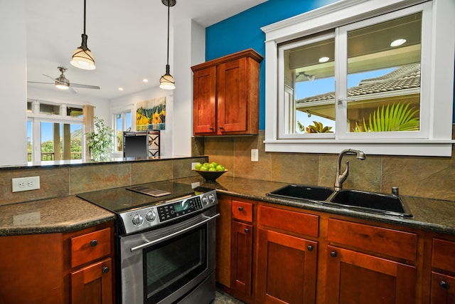 kitchen with pendant lighting, sink, ceiling fan, decorative backsplash, and stainless steel range with electric cooktop