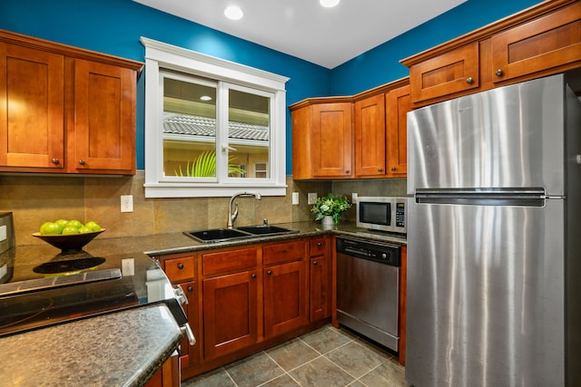 kitchen with decorative backsplash, appliances with stainless steel finishes, sink, and tile patterned flooring