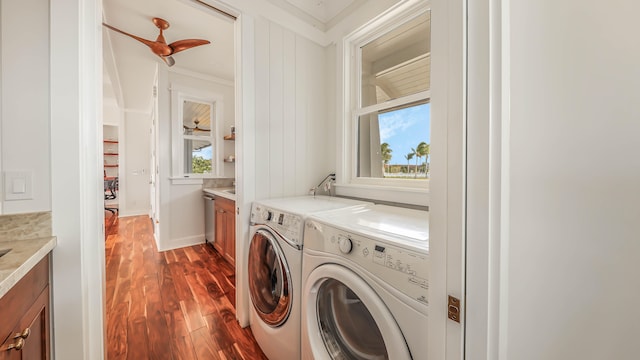 laundry area featuring laundry area, baseboards, ornamental molding, dark wood-type flooring, and separate washer and dryer