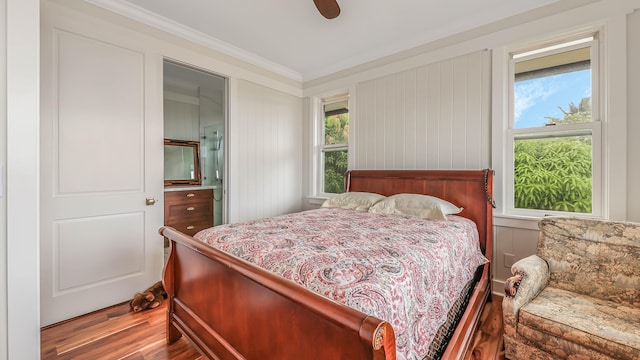 bedroom featuring ornamental molding, ceiling fan, and wood finished floors