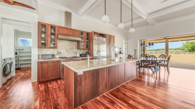 kitchen featuring dark wood-style flooring, beam ceiling, tasteful backsplash, high quality appliances, and under cabinet range hood