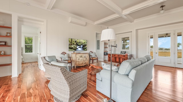 living area featuring hardwood / wood-style flooring, coffered ceiling, a wealth of natural light, and beamed ceiling