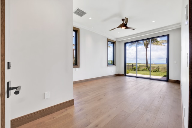 spare room featuring ceiling fan, light hardwood / wood-style flooring, and crown molding