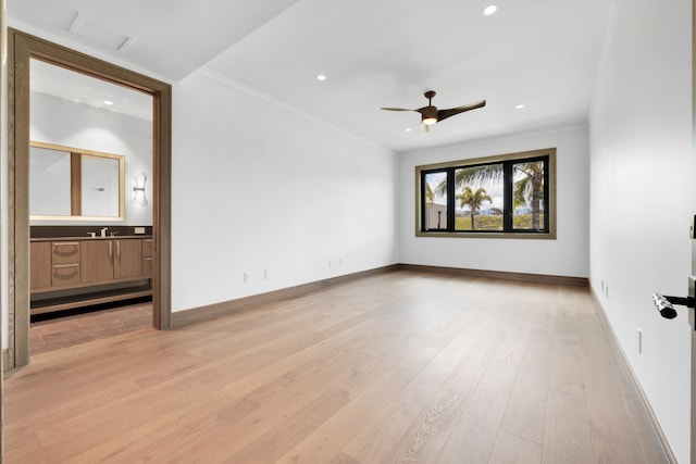 interior space featuring light hardwood / wood-style floors, ornamental molding, and ceiling fan