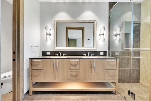 bathroom with tile patterned floors, toilet, walk in shower, and vanity