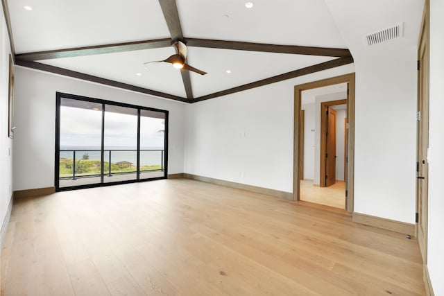 spare room with ceiling fan, lofted ceiling with beams, and light wood-type flooring