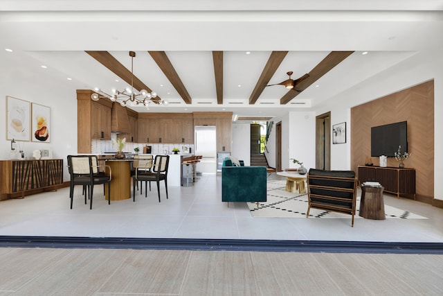 living room with ceiling fan with notable chandelier, light tile patterned flooring, and beamed ceiling