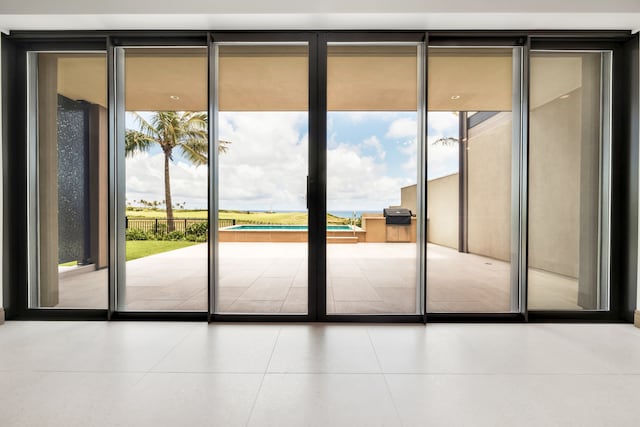 doorway to outside featuring light tile patterned flooring