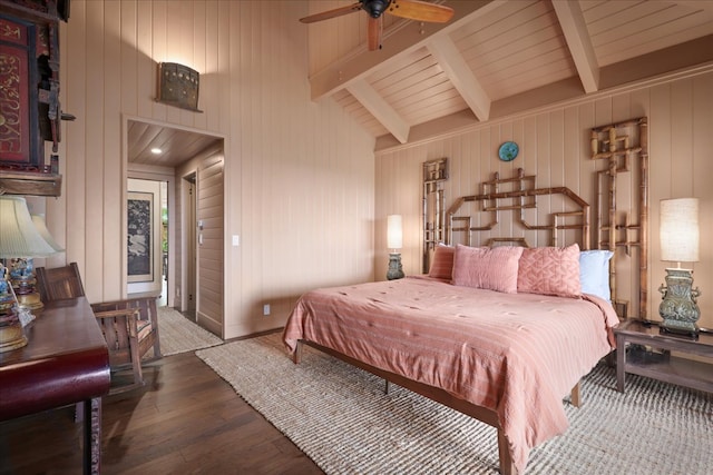 bedroom with ceiling fan, vaulted ceiling with beams, and hardwood / wood-style flooring