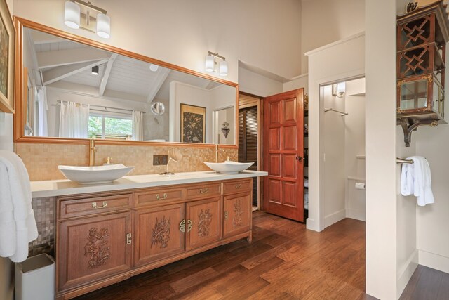 bathroom with shower with separate bathtub, lofted ceiling with beams, vanity, and hardwood / wood-style floors