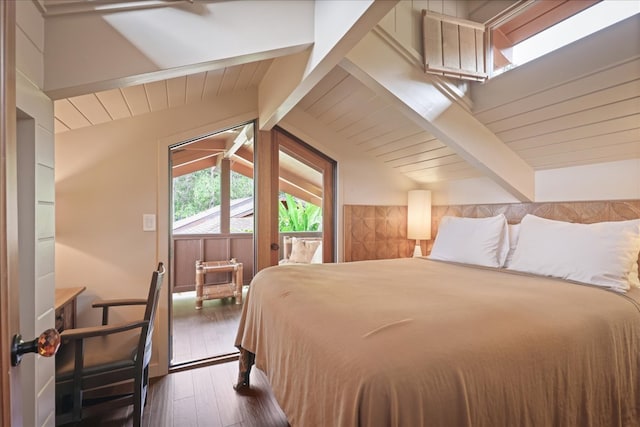 bedroom with lofted ceiling with beams and dark hardwood / wood-style flooring