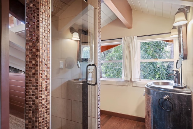 bathroom featuring lofted ceiling with beams, vanity, wood-type flooring, and a wealth of natural light