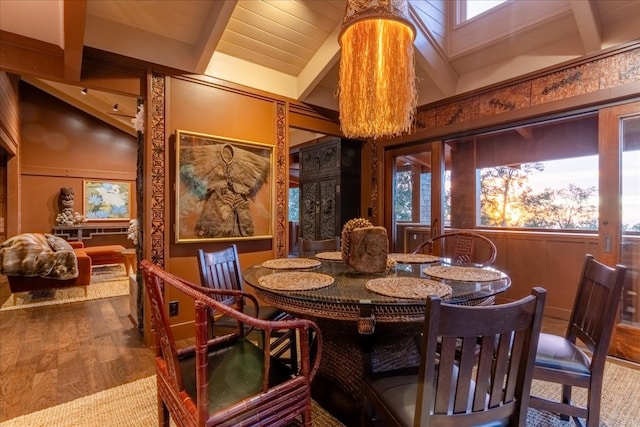 dining area featuring lofted ceiling with beams, plenty of natural light, and wood-type flooring