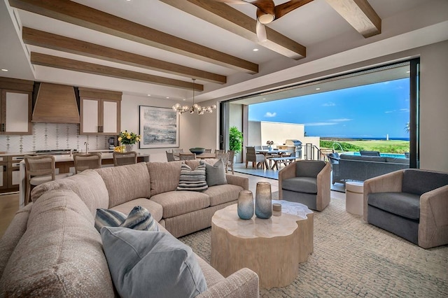 living room featuring beam ceiling and a chandelier