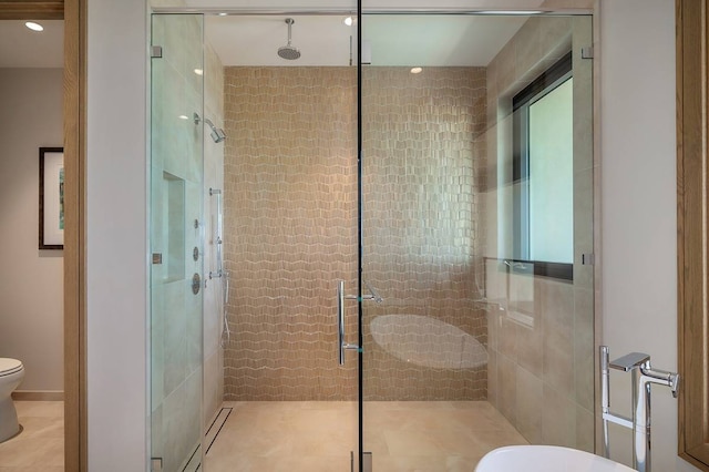 bathroom with an enclosed shower, tile patterned floors, and toilet