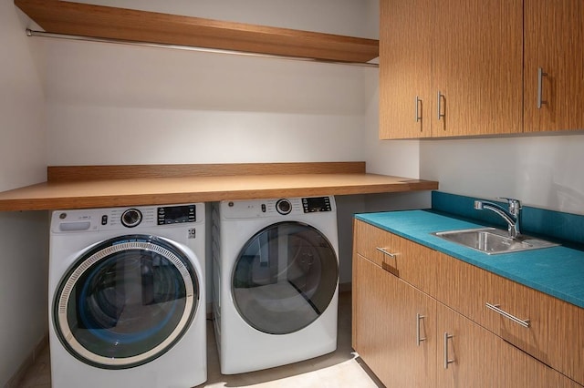 laundry area with cabinets, sink, and washing machine and dryer