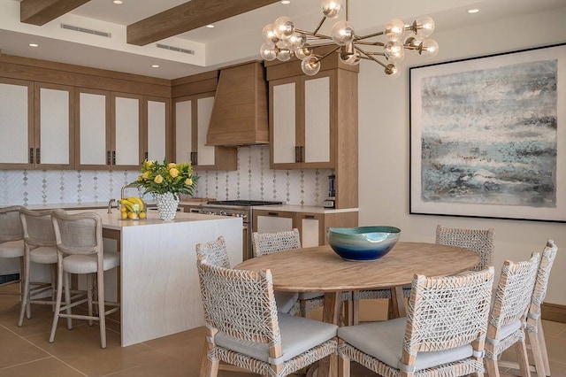 kitchen with decorative backsplash, pendant lighting, custom exhaust hood, high end stove, and light tile patterned floors