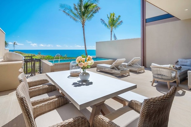 exterior space with a water view and an outdoor living space