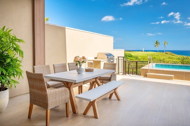 view of patio / terrace with grilling area and a water view