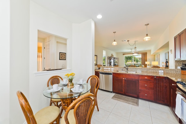 kitchen with sink, hanging light fixtures, stainless steel dishwasher, light stone countertops, and electric stove