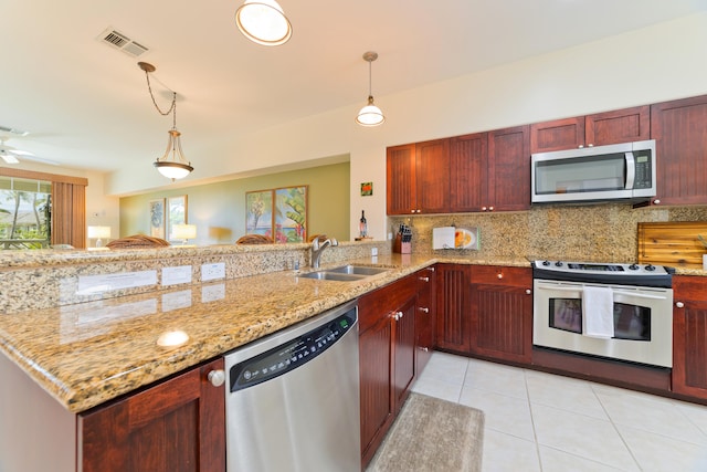 kitchen featuring sink, backsplash, stainless steel appliances, light stone countertops, and kitchen peninsula