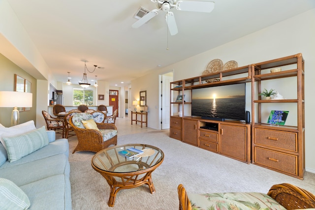 carpeted living room with ceiling fan