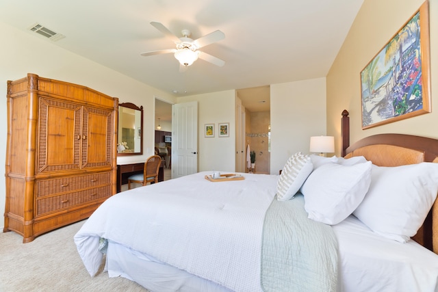 carpeted bedroom with ceiling fan and built in desk