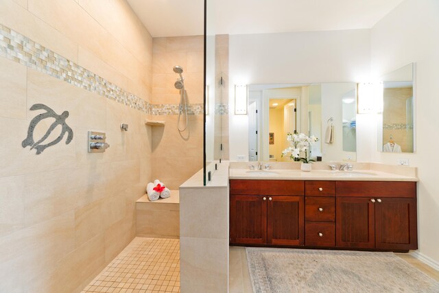 bathroom with vanity and a tile shower