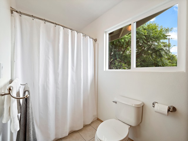 bathroom with toilet and tile patterned flooring