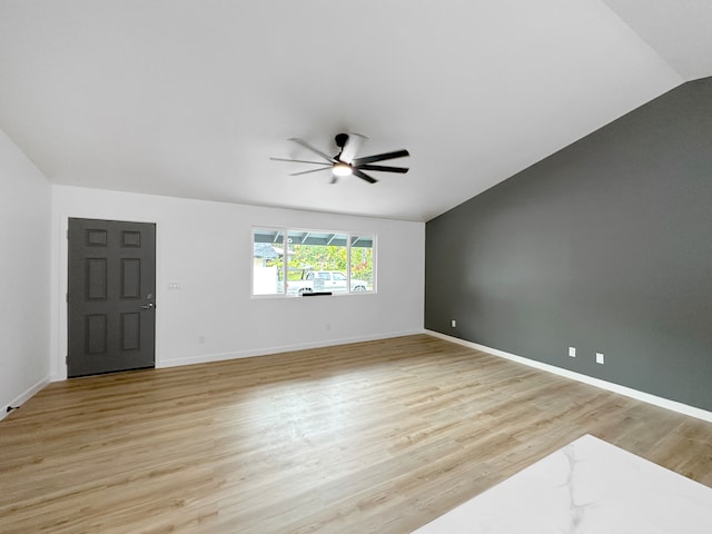 unfurnished room with lofted ceiling, ceiling fan, and light hardwood / wood-style floors