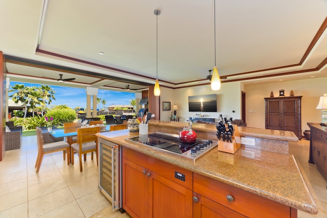 kitchen with ceiling fan, a raised ceiling, stovetop, wine cooler, and light tile patterned floors