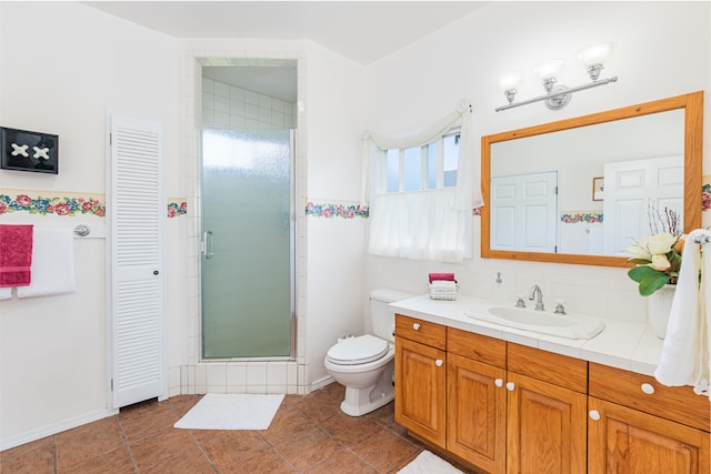 bathroom with vanity, a shower with shower door, a healthy amount of sunlight, and toilet