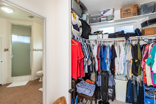 spacious closet featuring tile patterned flooring