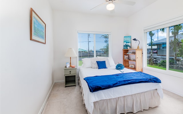 bedroom featuring ceiling fan and light colored carpet