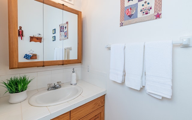 bathroom featuring vanity and tasteful backsplash