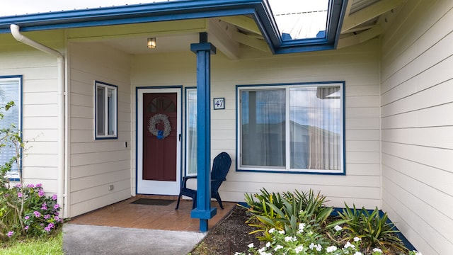 view of exterior entry featuring covered porch